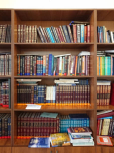 istock Defocused image. Multi-colored books on the bookshelf in the library. The bokeh effect 925640208