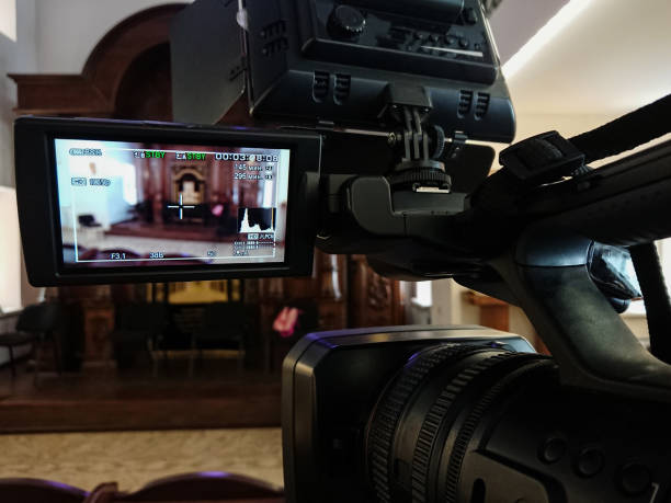 istock Videography in the interior. Digital video camera with LCD display. Led on-camera light 925640234