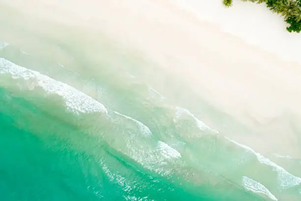 Top view of beautiful white sand beach with turquoise sea water in Southern Thailand - aerial drone shot