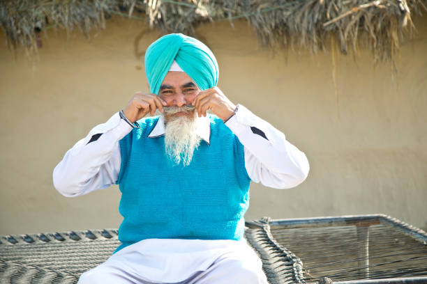 istock Old Indian man holding his mustache 925644466