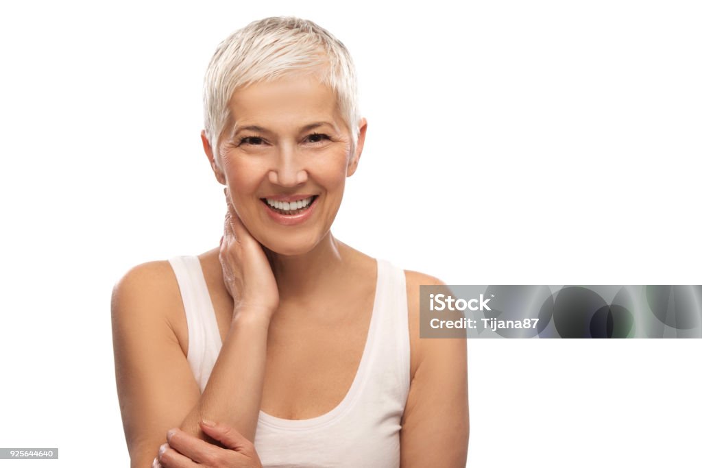 Portrait of a beautiful elderly woman, smiling, isolated on white background White Background Stock Photo