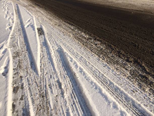 istock Black ice and snow on road 925648592