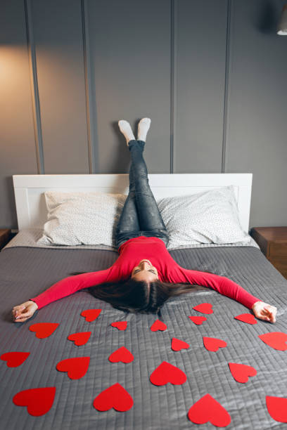 istock Beautiful young woman surrounded with red hearts 925653912