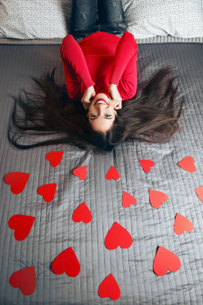 istock Beautiful young woman surrounded with red hearts 925654006