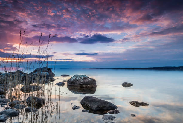 istock colorful sunset by a lake with a rocky beach 925657428