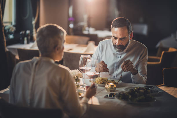 istock Mature couple sitting on a dinner in a restaurant. 925659996