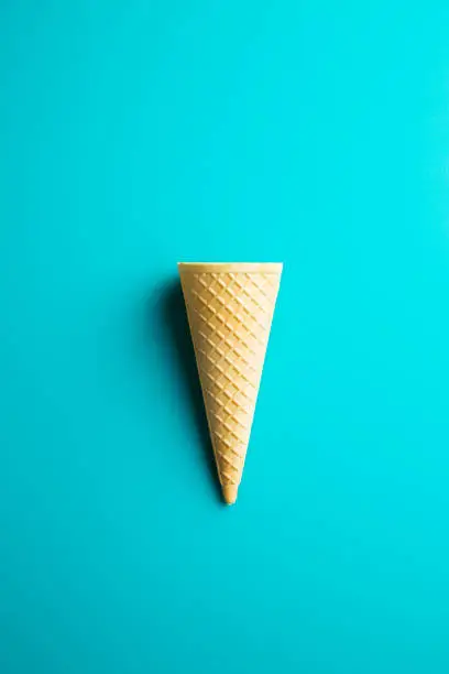 Sweet wafer cone on color background. Top view.