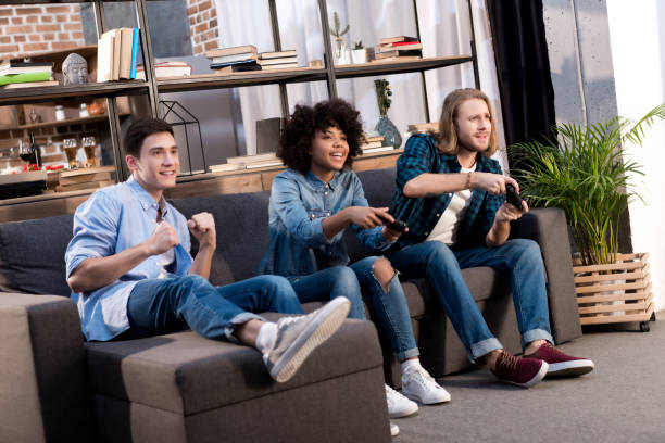 istock multicultural friends playing video game at home 925668560
