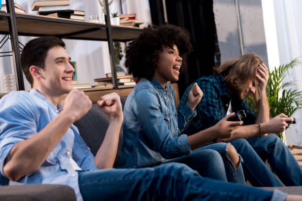 istock multicultural friends playing video game at home 925668744