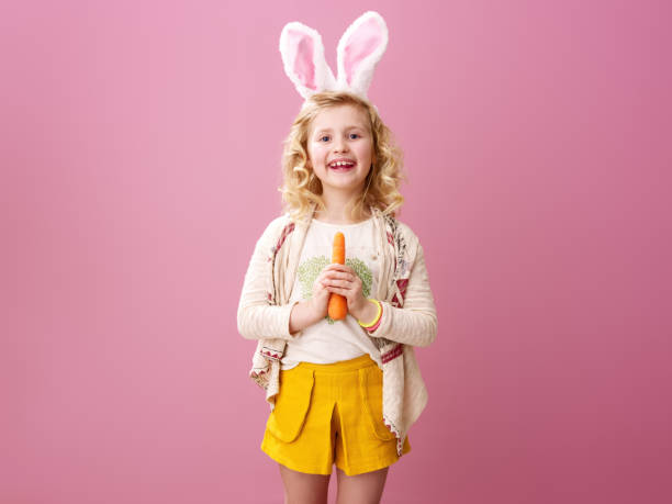 istock happy modern girl on pink background with carrot 925671802