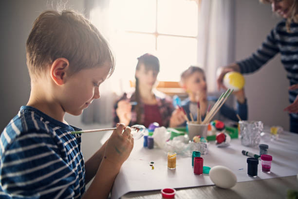 istock Family having fun painting easter eggs 925672544