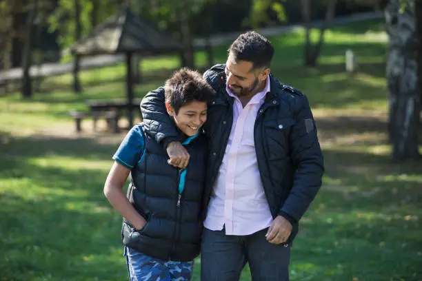 Father and son in public park