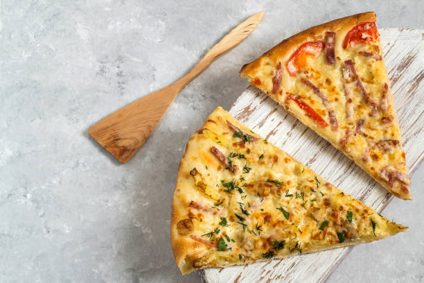 istock Two different pieces of pizza on wooden board 925673966