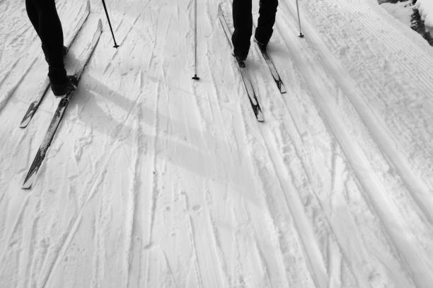 Two people cross country skiing stock photo