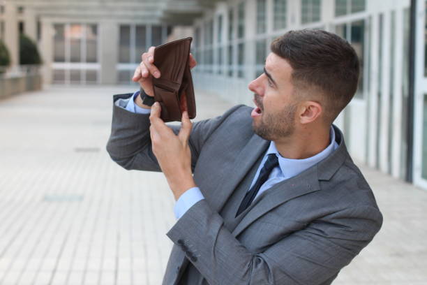 Broke businessman showing his empty wallet