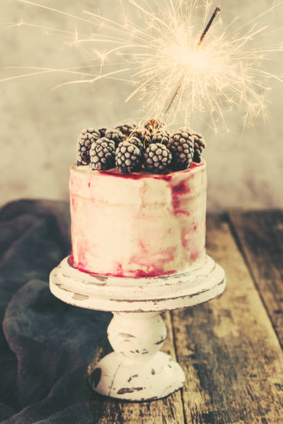 istock Birthday cake with sparkler on wooden vintage table 925678794