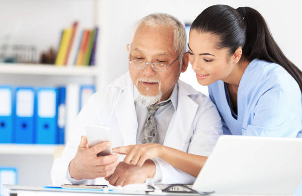 istock Nurse and doctor using mobile phone in cabinet 925681042