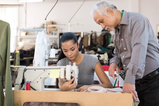 istock Senior tailor observing in textile factory 925681084