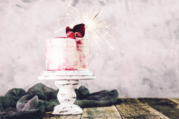 istock Birthday cake with sparkler on wooden vintage table 925681410