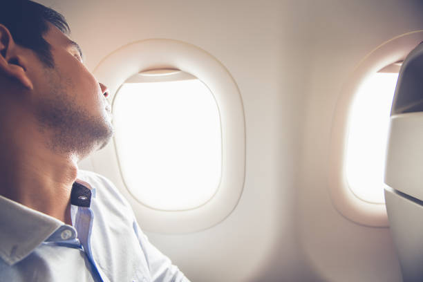 istock Tired passenger sleeping on the airplane at window seat 925681786