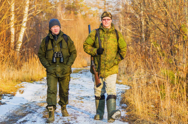 istock Two hunters in the forest in late autumn 925684560