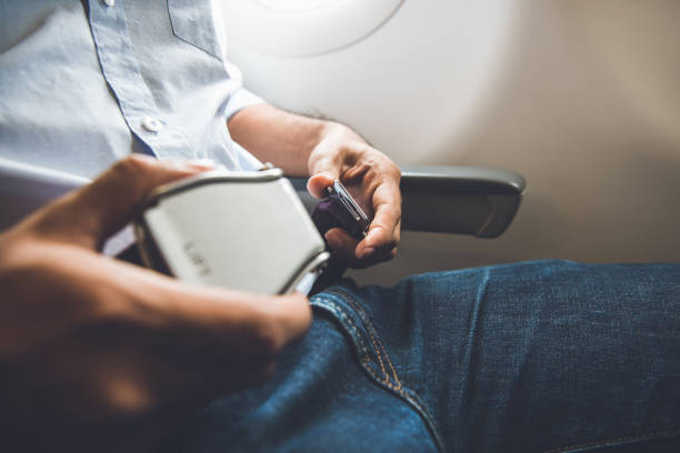 istock Passenger fastening seat belt while sitting on the airplane for safe flight 925684614
