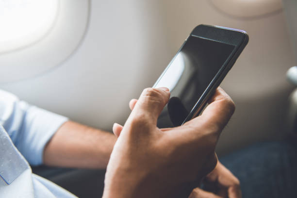 istock Passenger just turned off mobile phone on the airplane while traveling for safe flight 925685254