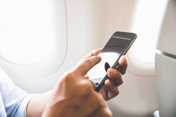 istock Male passenger using mobile phone on the airplane while traveling 925685600