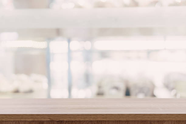 istock Empty wooden table top with blurred modern shopping mall background for product display and montage. 925689192