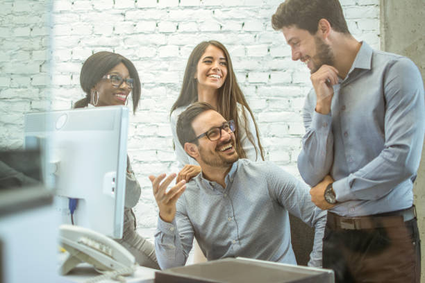 istock Happy cheerful business people talking in modern office. 925689372