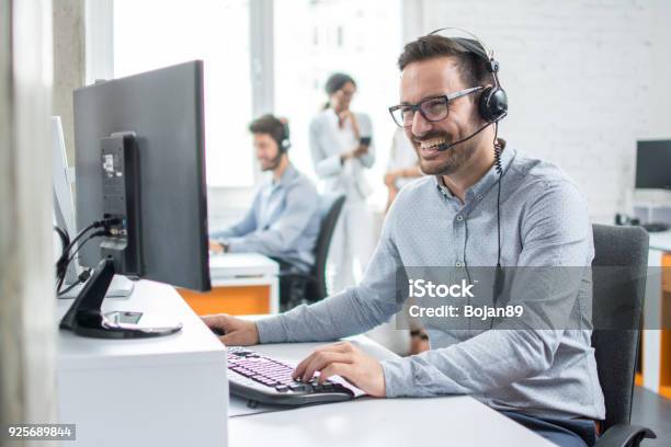 Smiling Customer Support Operator With Handsfree Headset Working In The Office Stock Photo - Download Image Now