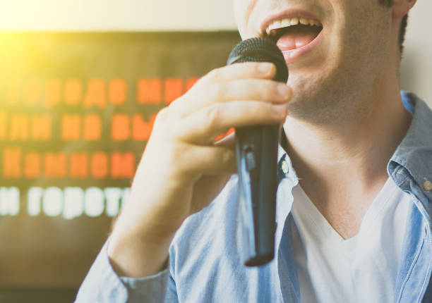 istock Man singing karaoke at home. Close-up view. 925697716