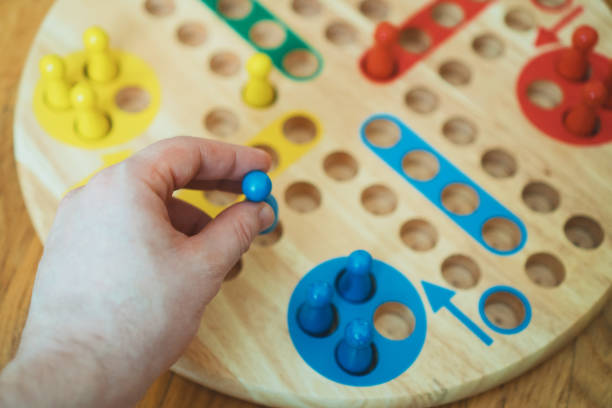 istock Man playing Ludo board game. Close-up view. 925697826