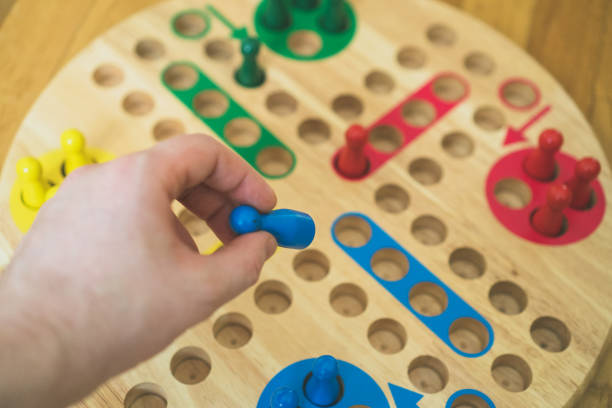 istock Man playing Ludo board game. Close-up view. 925697836