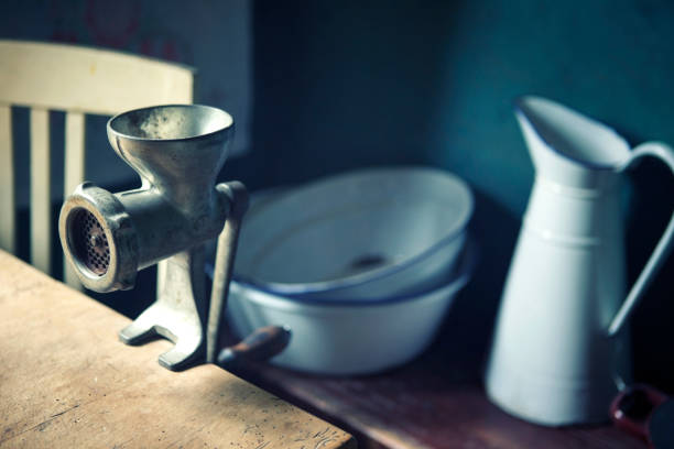istock vintage meat grinder on wooden table and bowl with jug 925701268