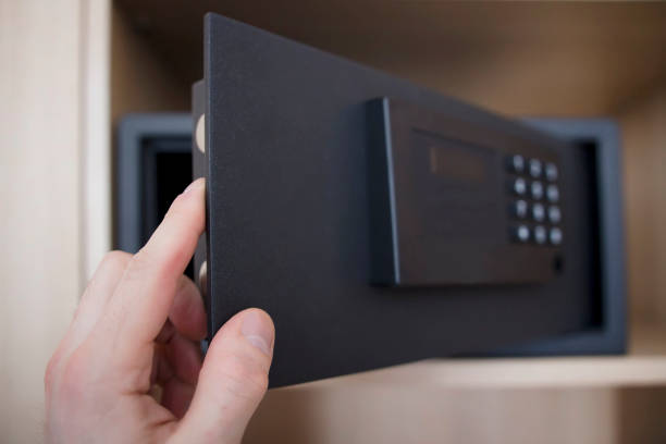 Man opens safe depository of valuables and money in his home. Keep the money in the safe at home. Safe, hand close-up. Man opens safe depository of valuables and money in his home. Keep the money in the safe at home. Safe, hand close-up key package stock pictures, royalty-free photos & images