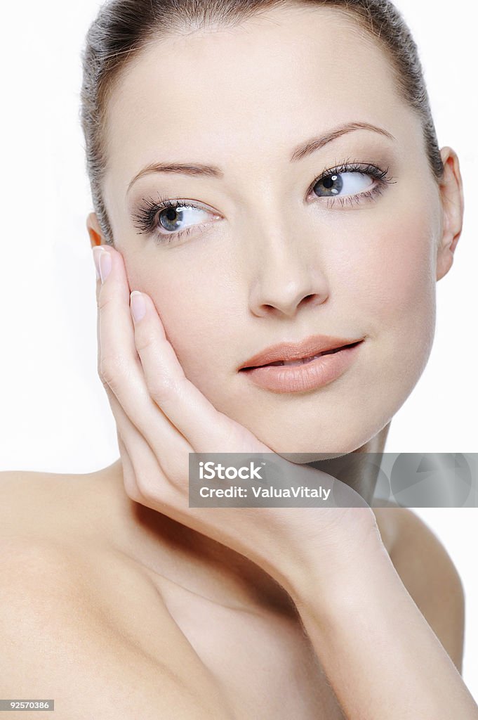 woman stroking her beautiful face portrait of young elegancy woman stroking her beautiful face 20-29 Years Stock Photo