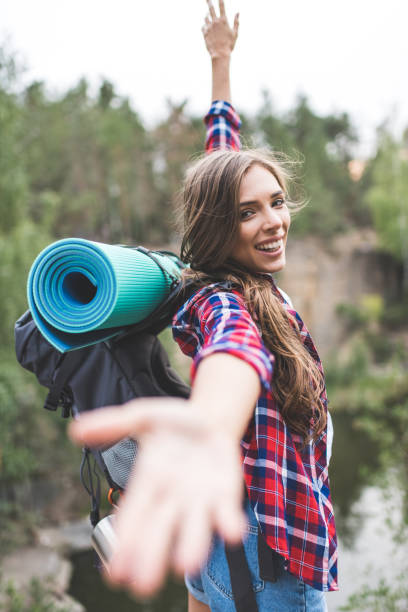 istock woman with trekking backpack 925705500