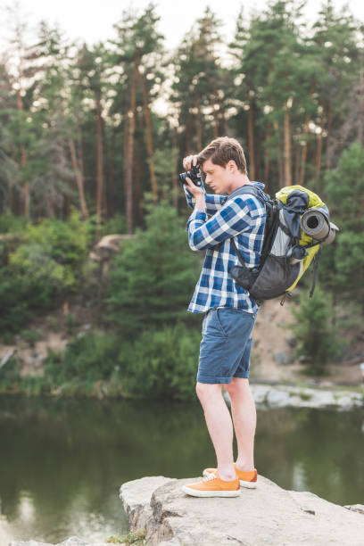 istock hiker taking photo of lake 925705780