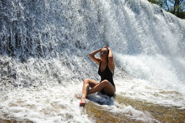 istock Woman relaxing in a natural Waterfall Spa 925706524