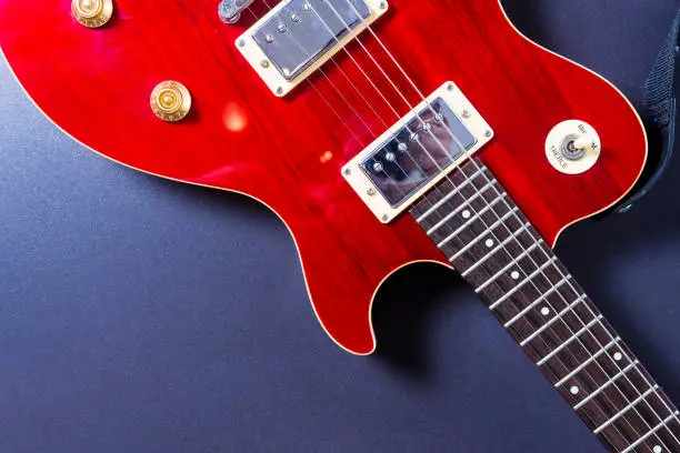 Photo of Red electric guitar on black background close-up. Music concept.