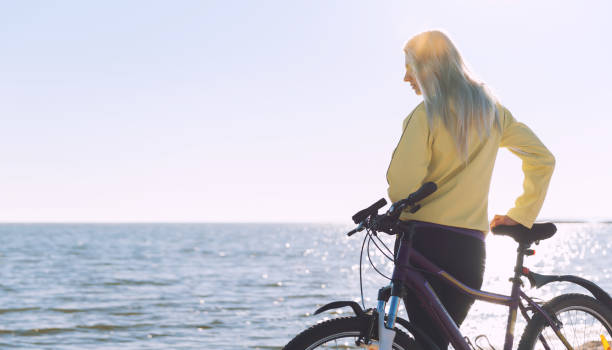 istock A girl on a bicycle by the sea 925709050