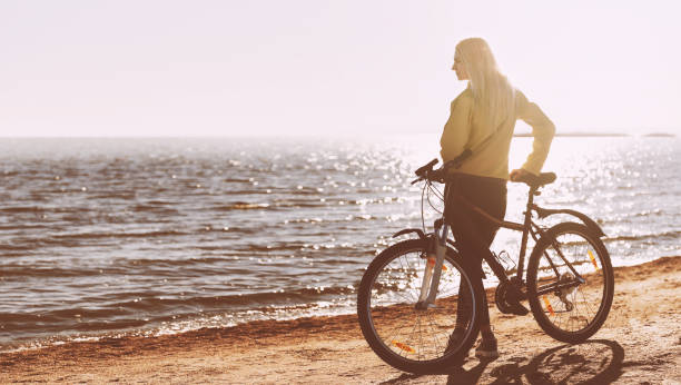 istock A girl on a bicycle by the sea 925709134