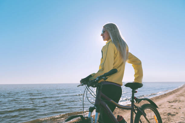 istock A girl on a bicycle by the sea 925709182