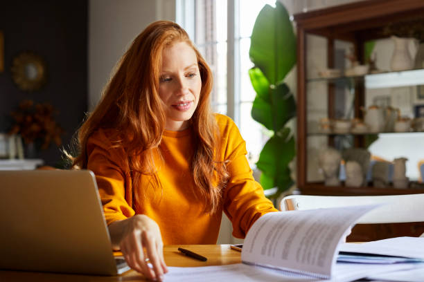 istock Businesswoman doing paperwork at home 925709910