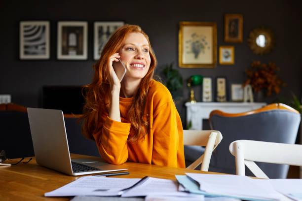 istock Smiling businesswoman using mobile phone at table 925709918