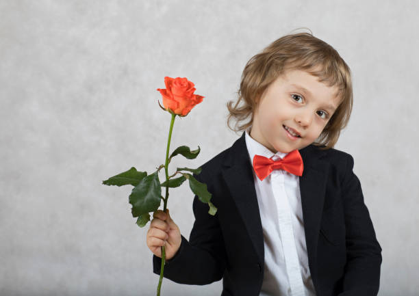 istock Small boy of four years with a rose. 925710188