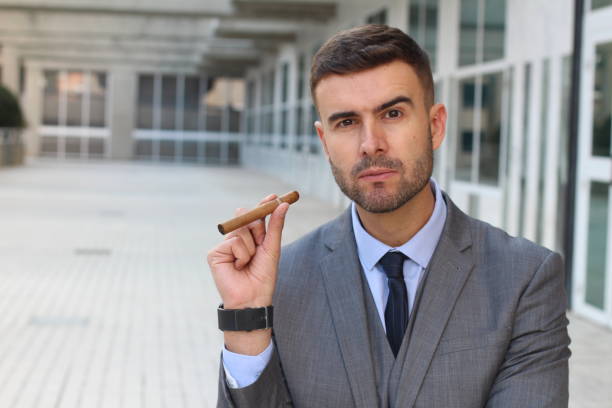 istock Businessman smoking a cigar in office space 925714090