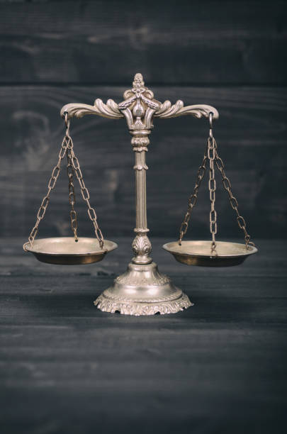istock Scales of Justice on a black wooden background. 925714432