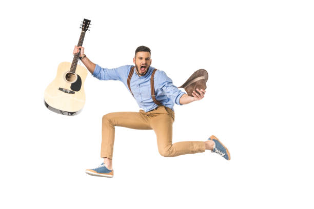 istock excited young musician with guitar and hat screaming at camera isolated on white 925714662